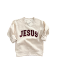 Child wearing a Jesus Varsity Crew Sweatshirt in Natural, showcasing a classic sporty font design.