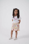 A young girl wearing a floral puff sleeve tee and matching shorts set available in white, pink, and yellow.