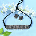 Silver-plated brass statement choker with black beads, Kundan stones, and pearl accents