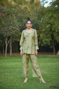Model wearing a Mahendi colored Mull Cotton Anya co-ord set featuring a matching top and pants.