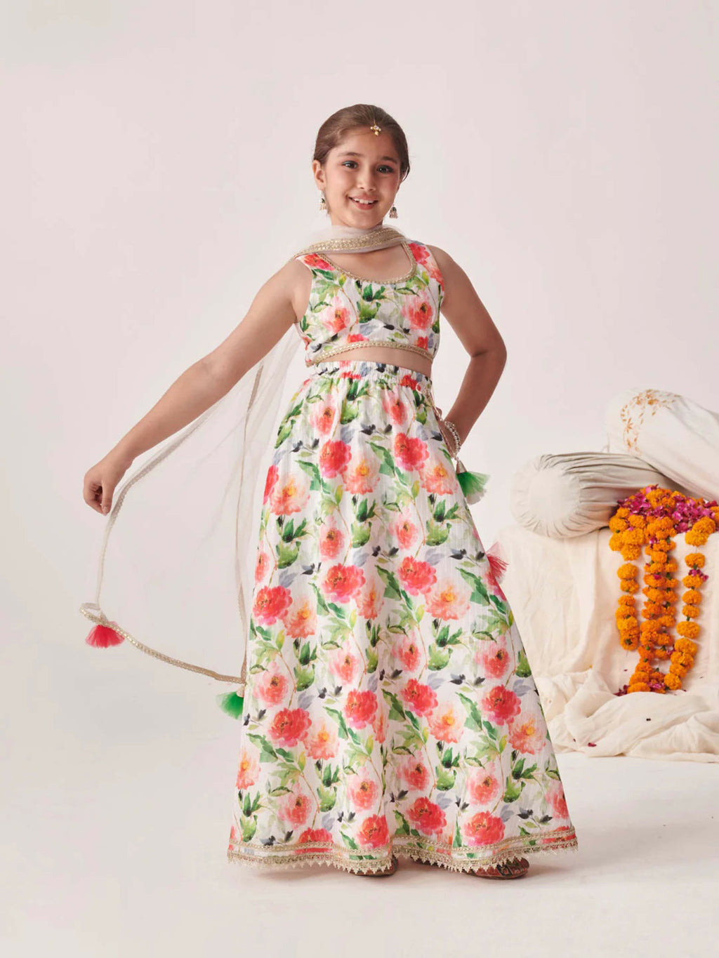 Girl wearing a vibrant multi-color silk blend lehenga choli set with a net dupatta.