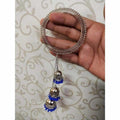 Stylish wide silver-tone bangle featuring three-step blue pearl jhumkas.