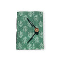 Handcrafted A5 journal in Fern Green made from recycled paper resting on a desk surface