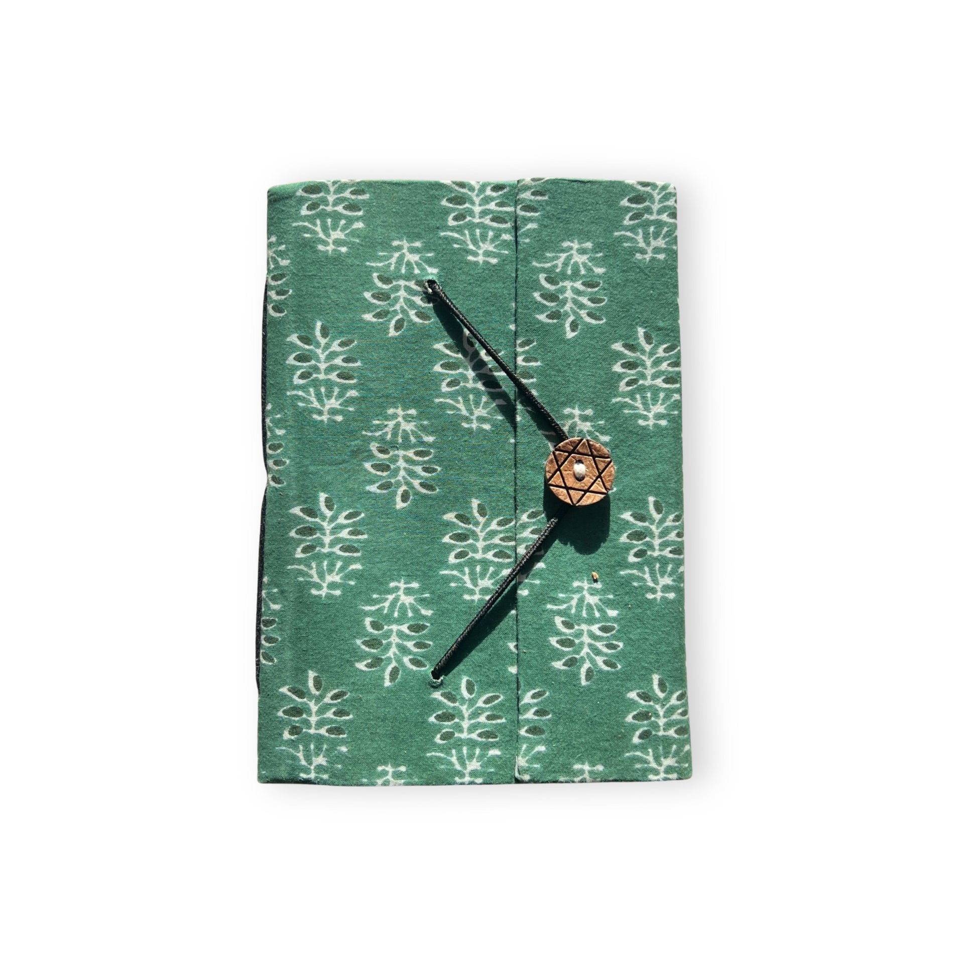 Handcrafted A5 journal in Fern Green made from recycled paper resting on a desk surface
