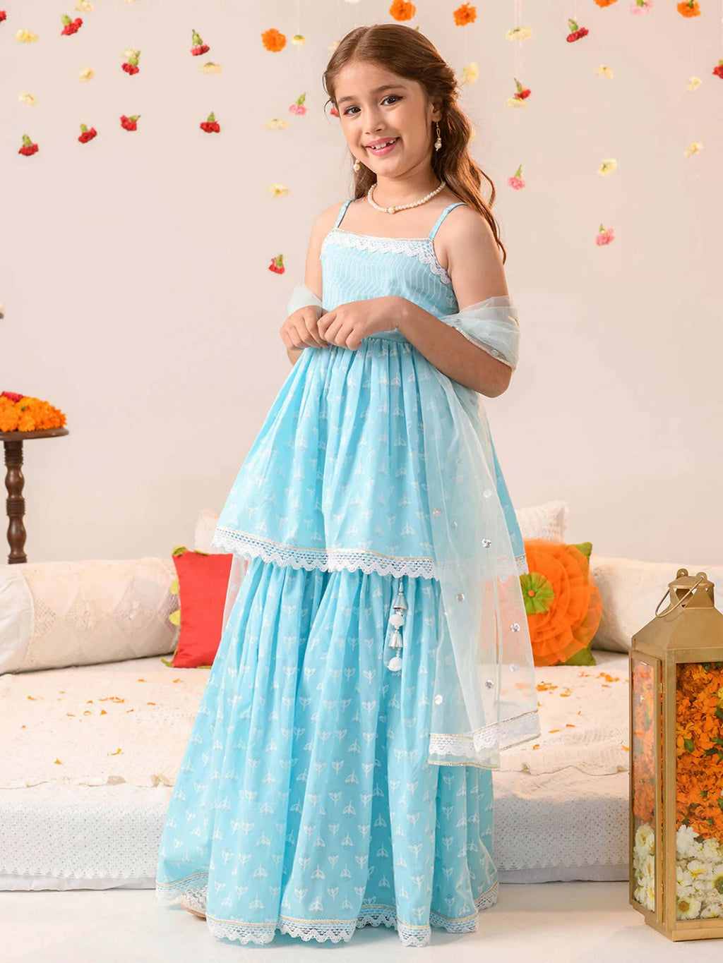 Girl wearing a sky blue pure cotton lehenga choli set, traditional ethnic festive wear.