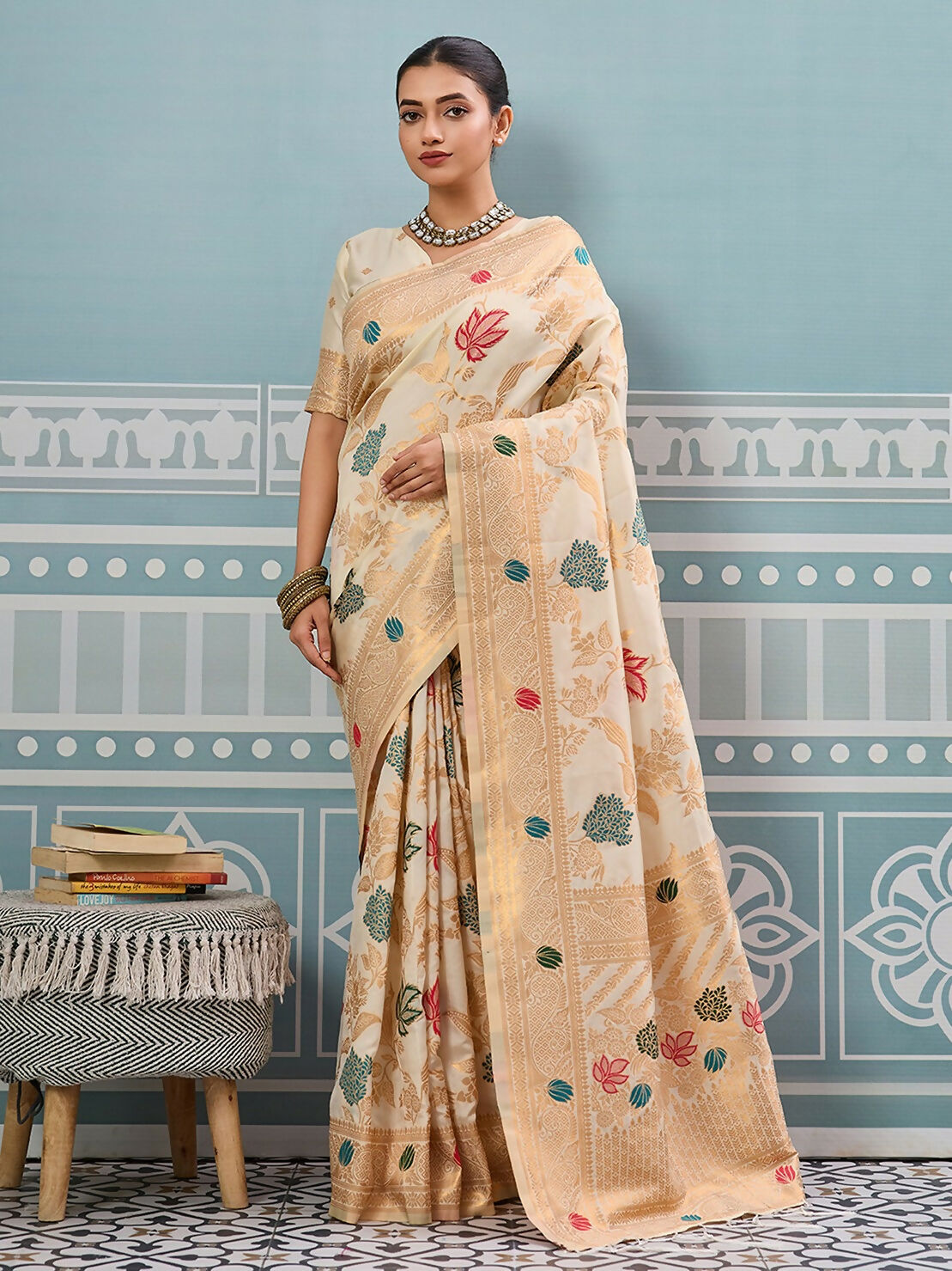 Elegant cream silk saree with matching silk blouse, draped in a traditional style