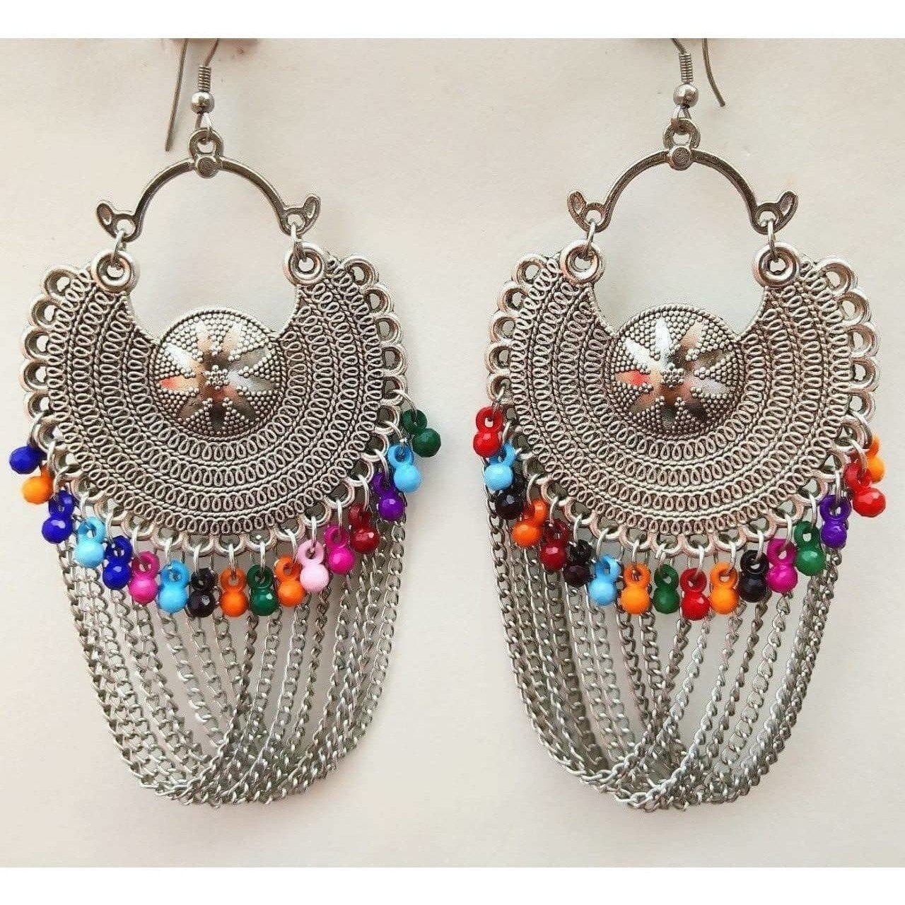 Silver oxidized half moon Chandbali earrings with multi-color pearl accents and dangling chains.