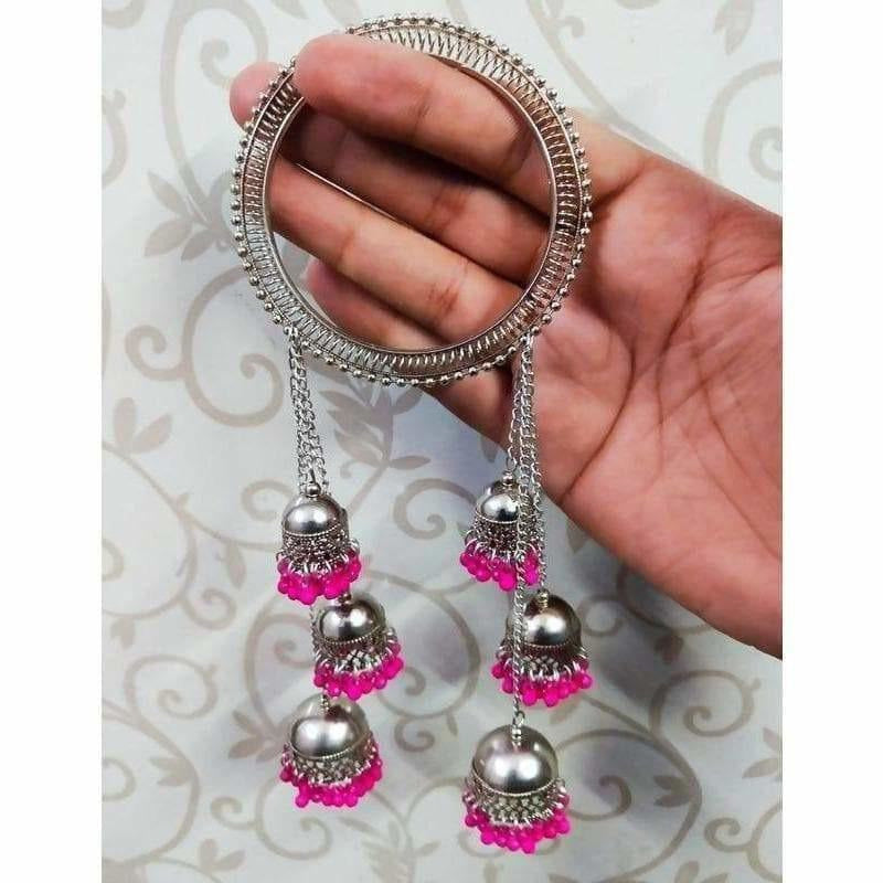 Wide silver bangle featuring pink pearl accents and cascading jhumka chain drapes