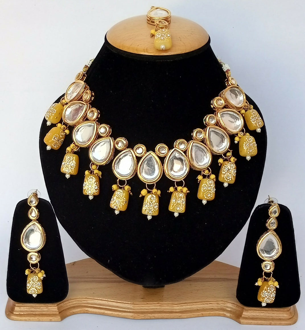 Yellow Kundan stone necklace set with gold-plated finish