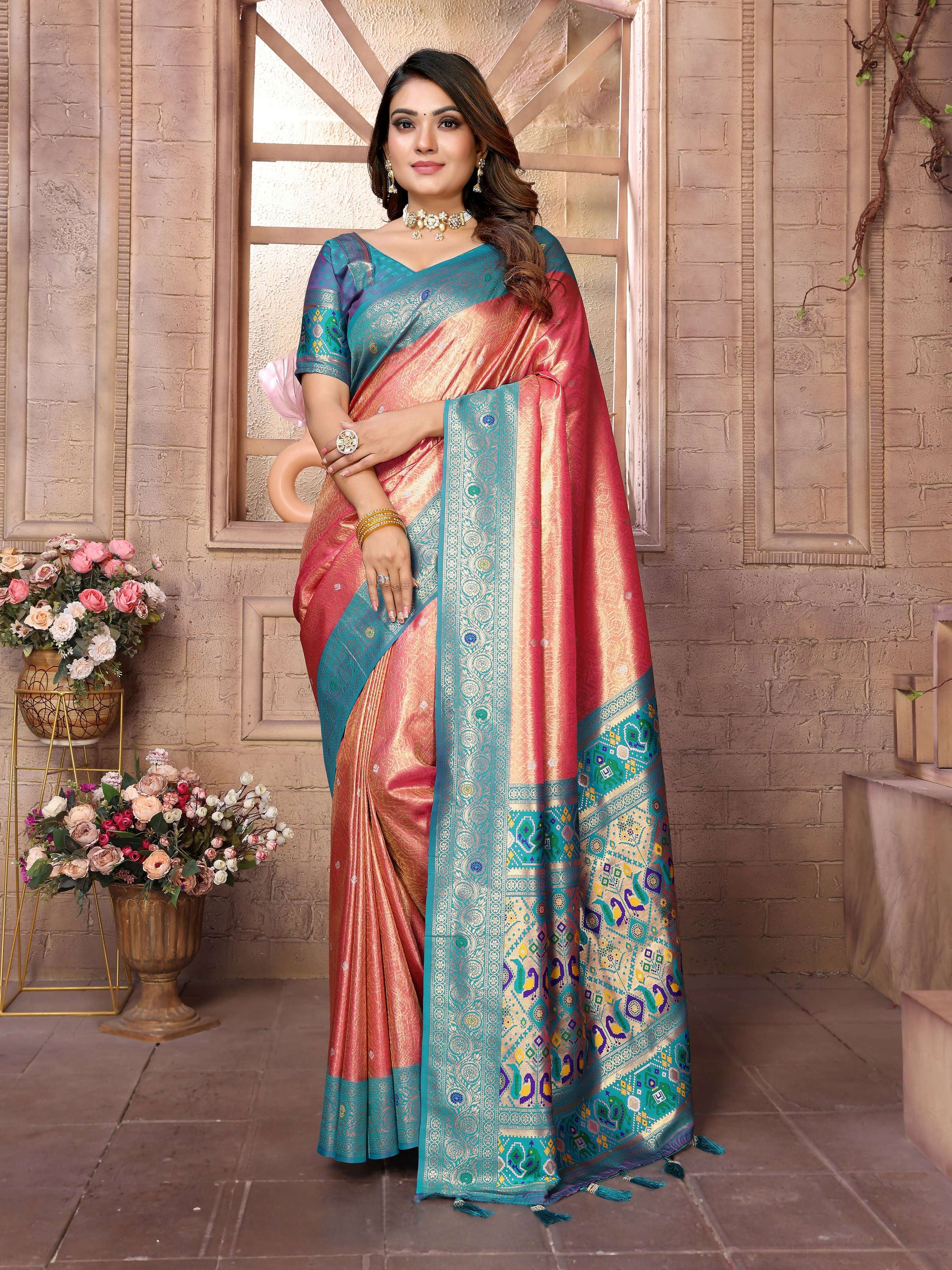 Red Banarasi tissue silk saree featuring intricate weaving patterns and a metallic luster.