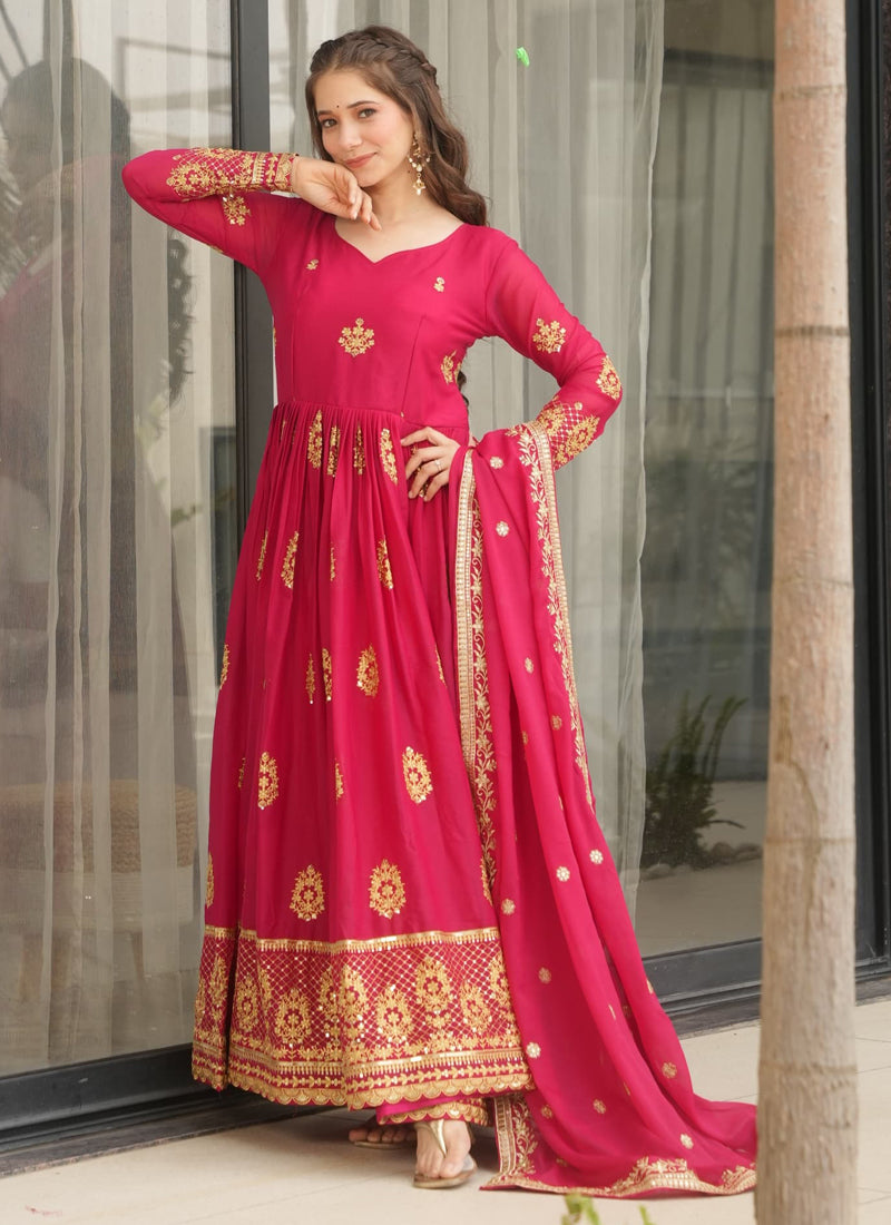 Red star georgette gown with detailed zari embroidery and a coordinated dupatta.