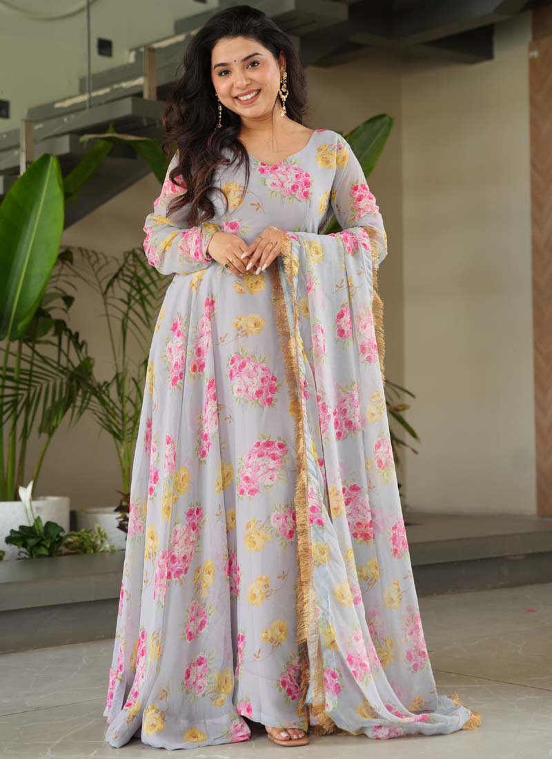 Woman wearing a light grey faux georgette gown with digital prints and a matching dupatta