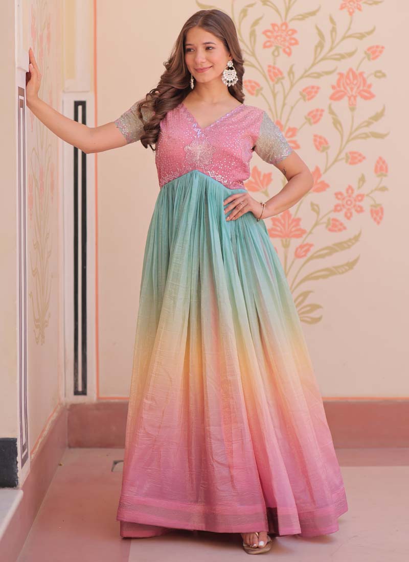 Model wearing a multi-color georgette embroidered gown with intricate beadwork and flowy chiffon fabric.
