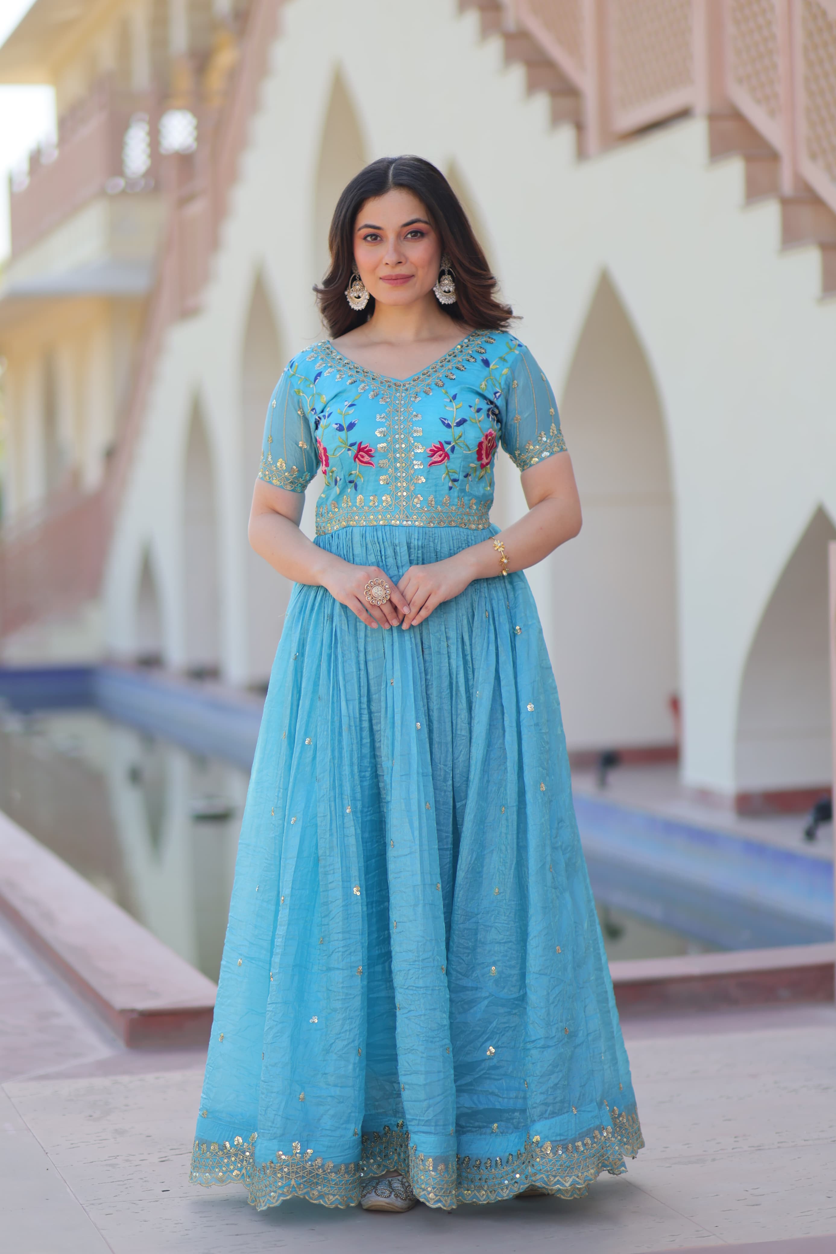 Sky blue gown with gold crush finish, multi-thread embroidery, and zari sequin work