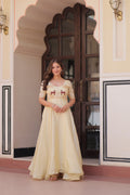 Off-white gown in gold crush fabric with intricate bead embroidery