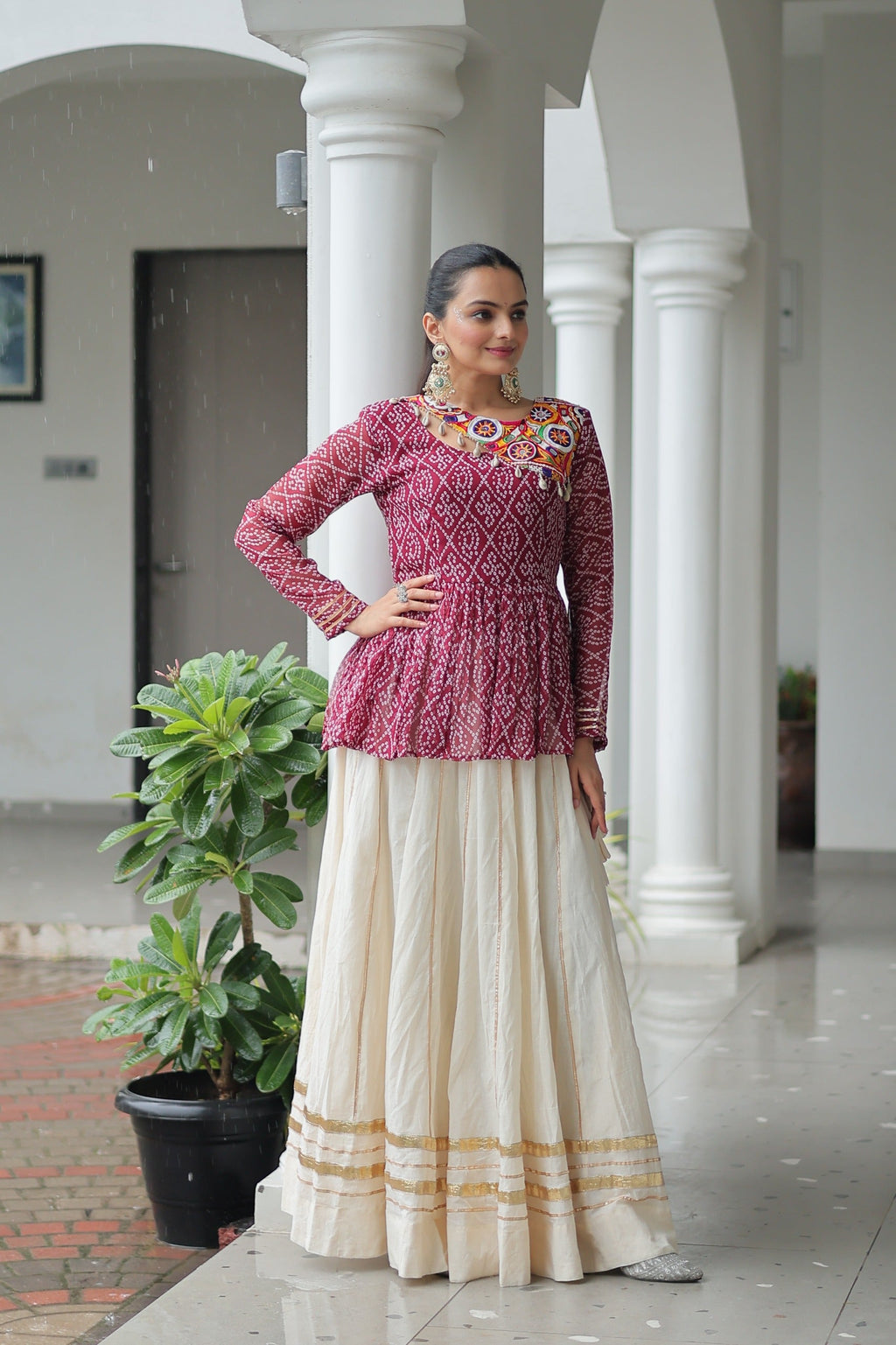 Wine Bandhani print Navaratri lehenga with detailed Kutchi Gamthi patchwork and Gota-Patti trim.