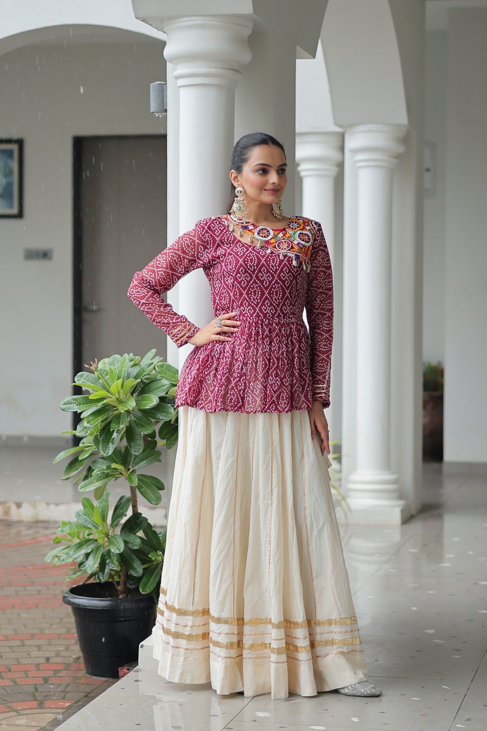 Wine Bandhani print Navaratri lehenga with detailed Kutchi Gamthi patchwork and Gota-Patti trim.