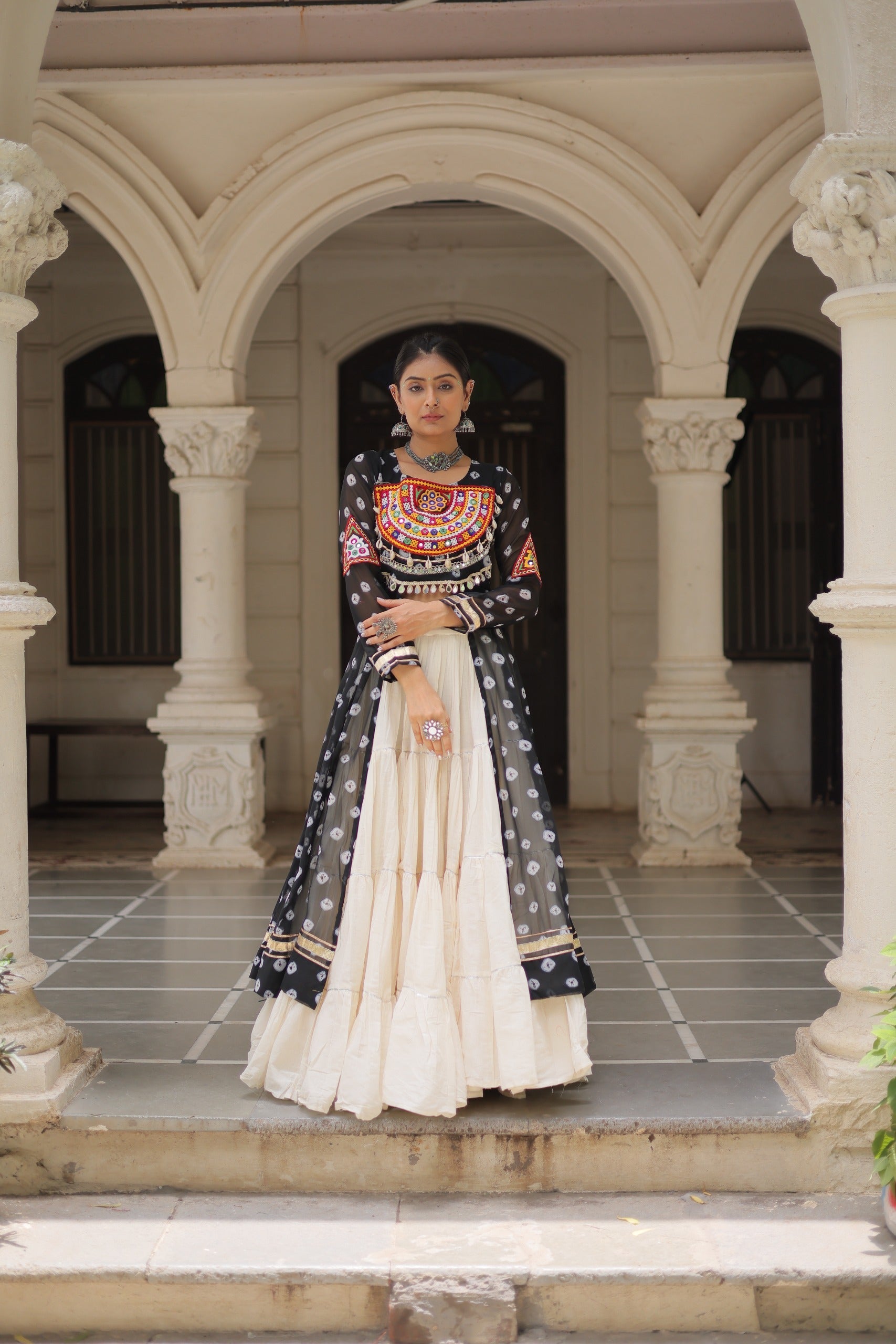 Black georgette Bandhani print lehenga with vibrant Kutchi patchwork detail and 12-meter flair