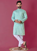 Toddler boy wearing a sky blue Roman silk kurta with intricate handwork and matching pajama.