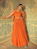 A beautiful orange silk floor-length wedding gown by Aarshi Fashions