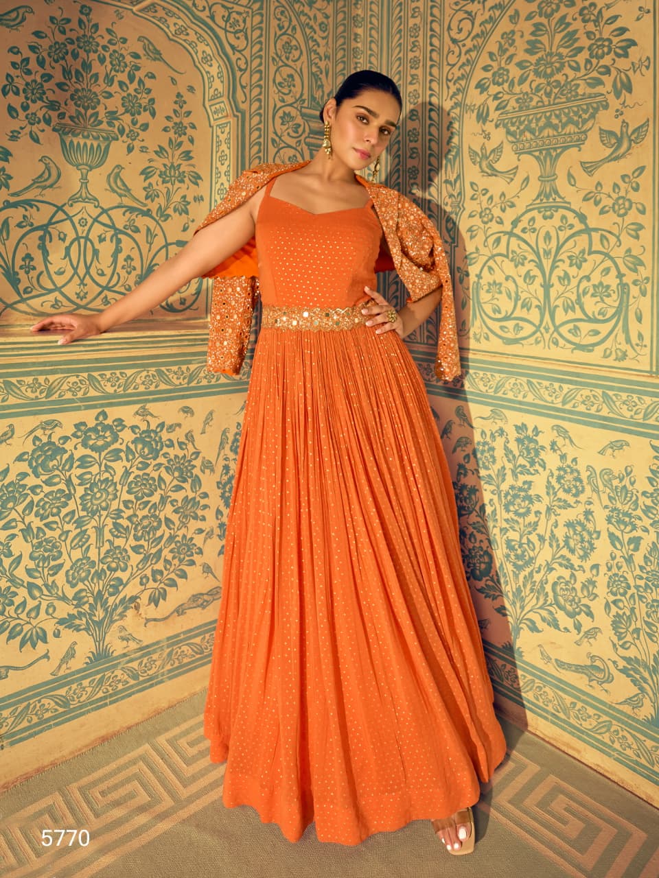 A beautiful orange silk floor-length wedding gown by Aarshi Fashions
