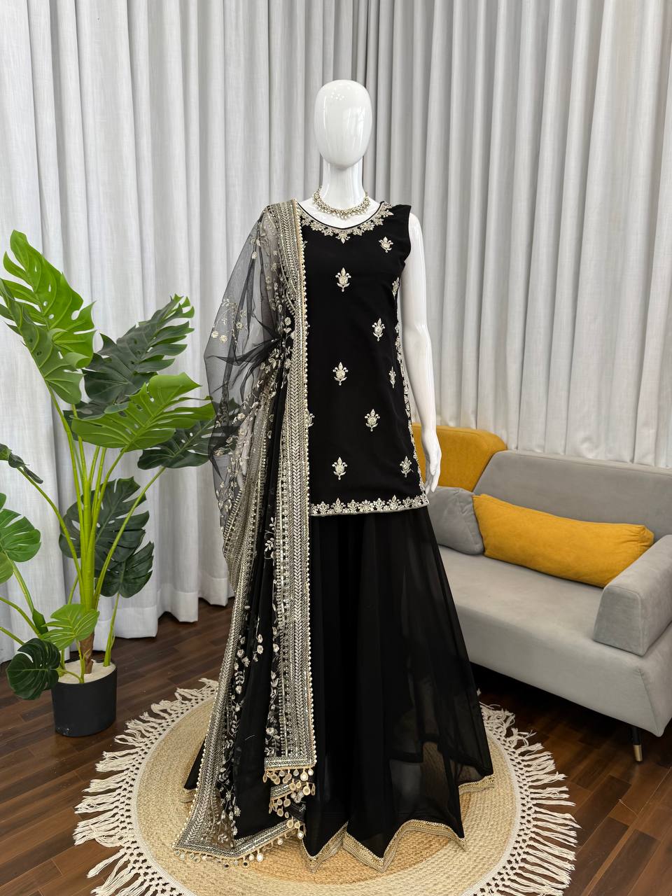 Front view of a black georgette palazzo suit featuring detailed thread and sequence embroidery work.
