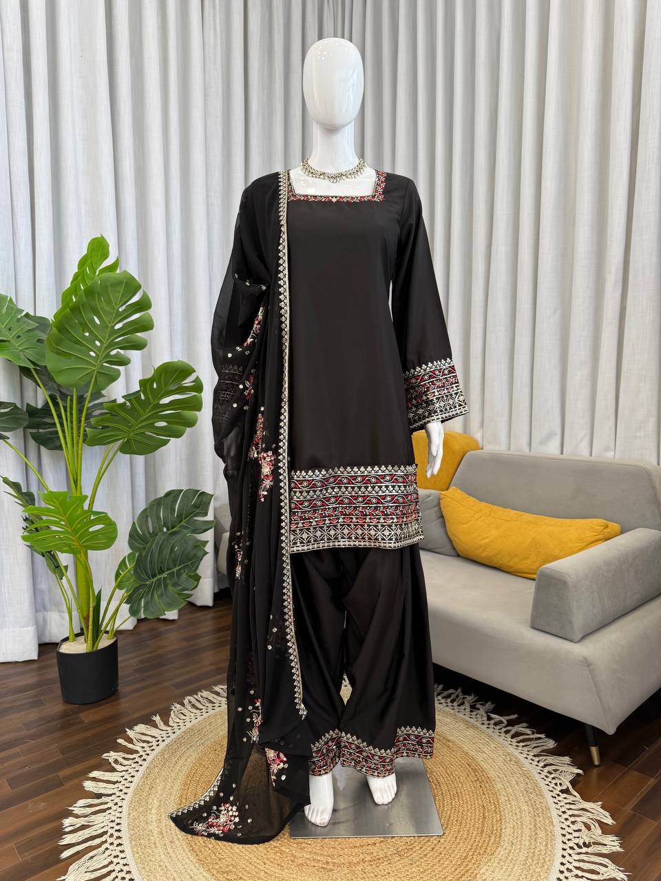 A sophisticated black crepe designer farshi palazzo suit with detailed thread and sequence embroidery.