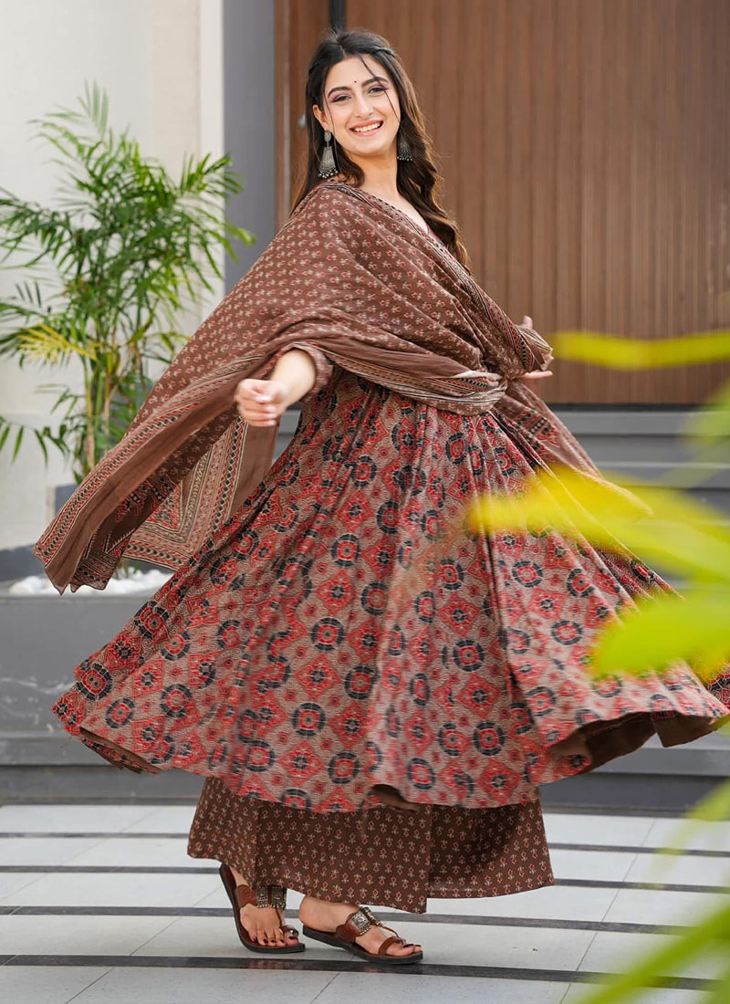 Woman wearing a multi-color muslin digital print designer salwar suit with intricate patterns.