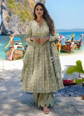 Baby wearing a green pure muslin digital printed designer salwar suit for festive occasions