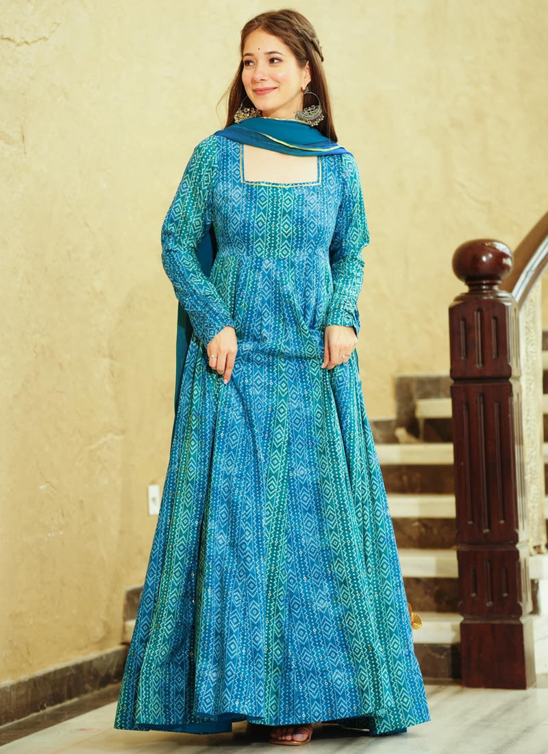 Woman wearing a Rama green georgette designer gown with intricate digital prints for festive occasions.