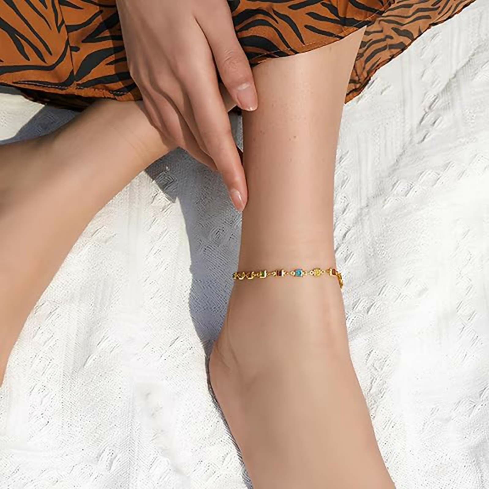 Adjustable golden alloy anklet for women with blue accents, ideal for a beach-chic aesthetic.