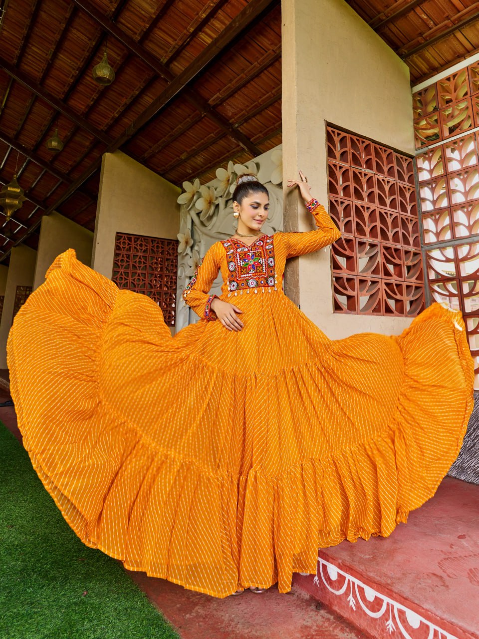 Yellow georgette festive gown with traditional Bandhani print and Kutchi patchwork design
