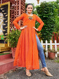 Woman wearing an orange Bandhani print maxi kurti with multi-colored Kutchi patch-work and long sleeves.