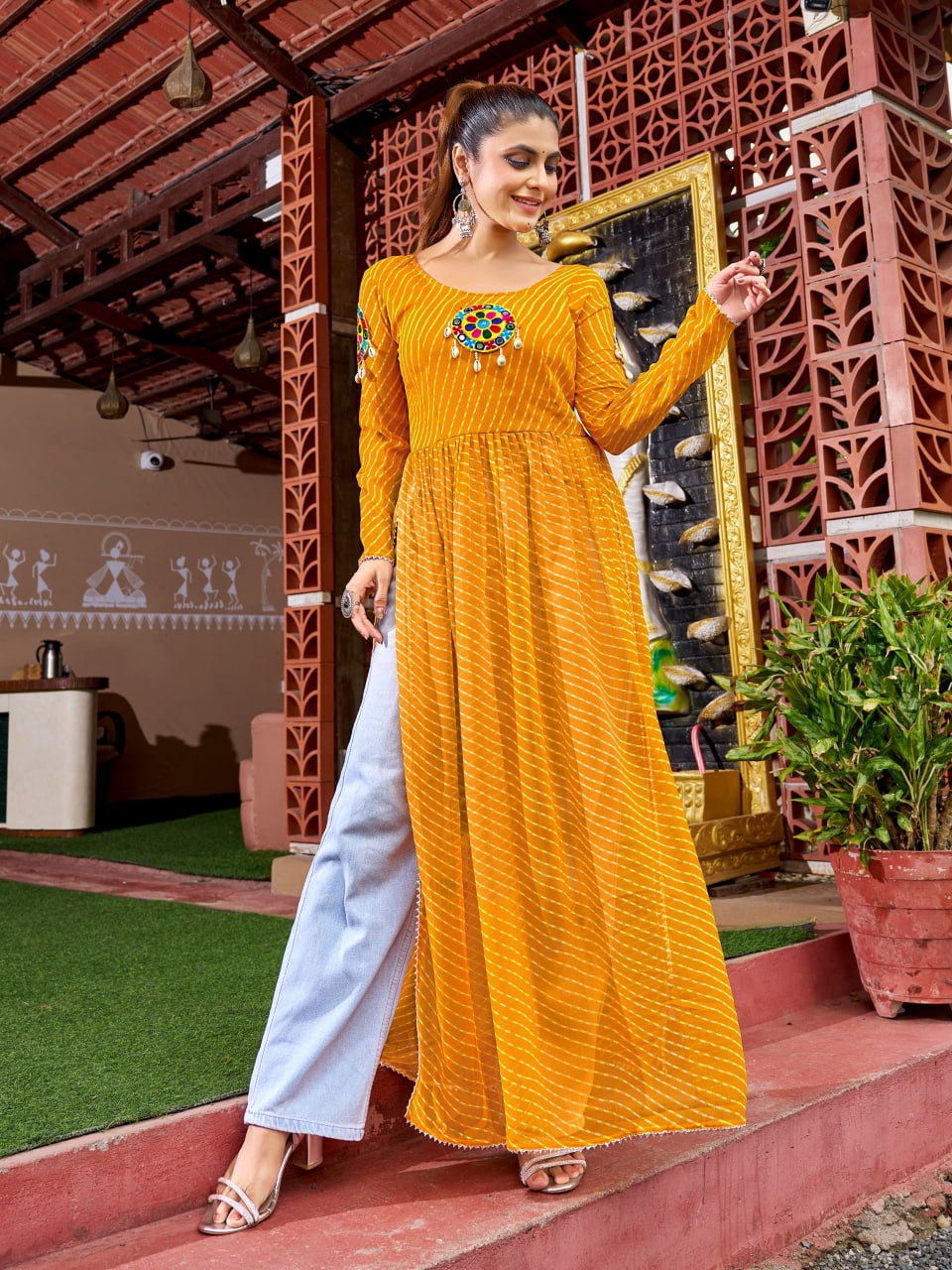Yellow georgette kurti featuring traditional Bandhani print and intricate Kutchi patchwork