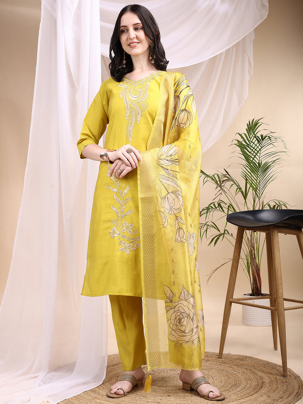 Woman wearing a yellow Chanderi embroidered kurta with pants and a printed dupatta