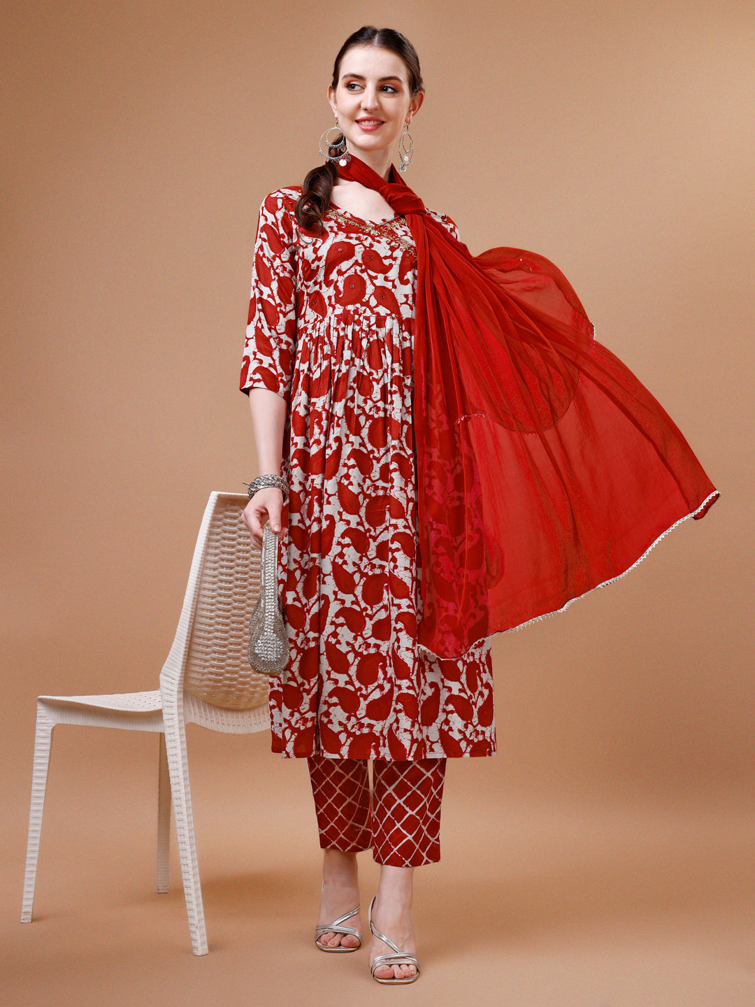 Woman wearing a multicolor embroidered angrakha style flared anarkali kurta with matching pants and dupatta.