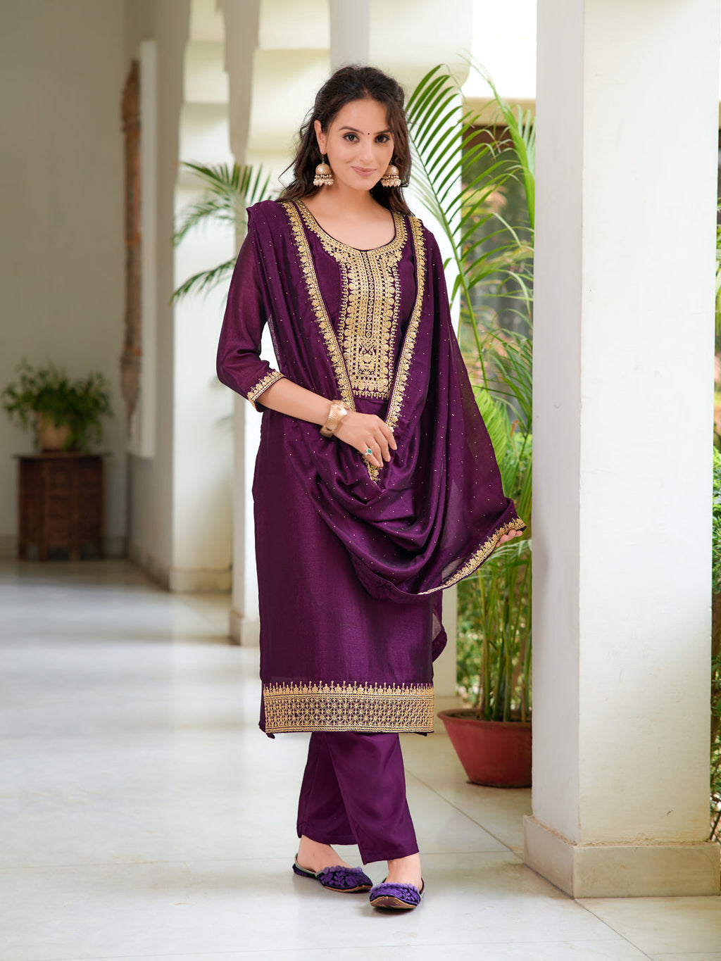 Model wearing a wine-colored embroidered silk-blend kurta set with 3/4 sleeves