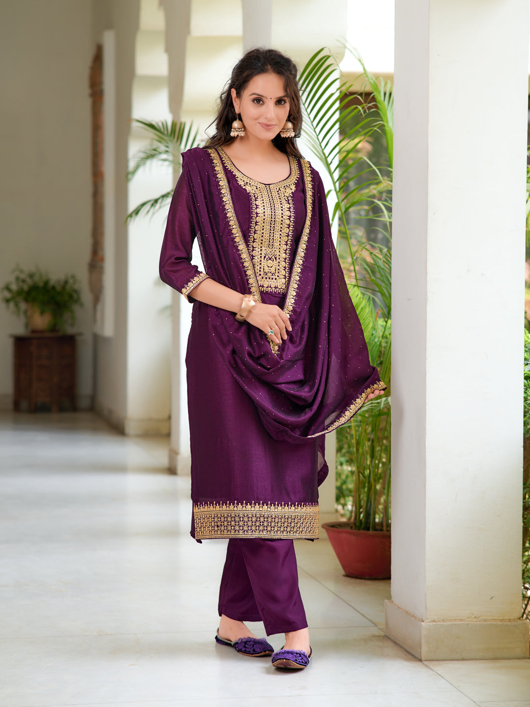 Model wearing a wine-colored embroidered silk-blend kurta set with 3/4 sleeves