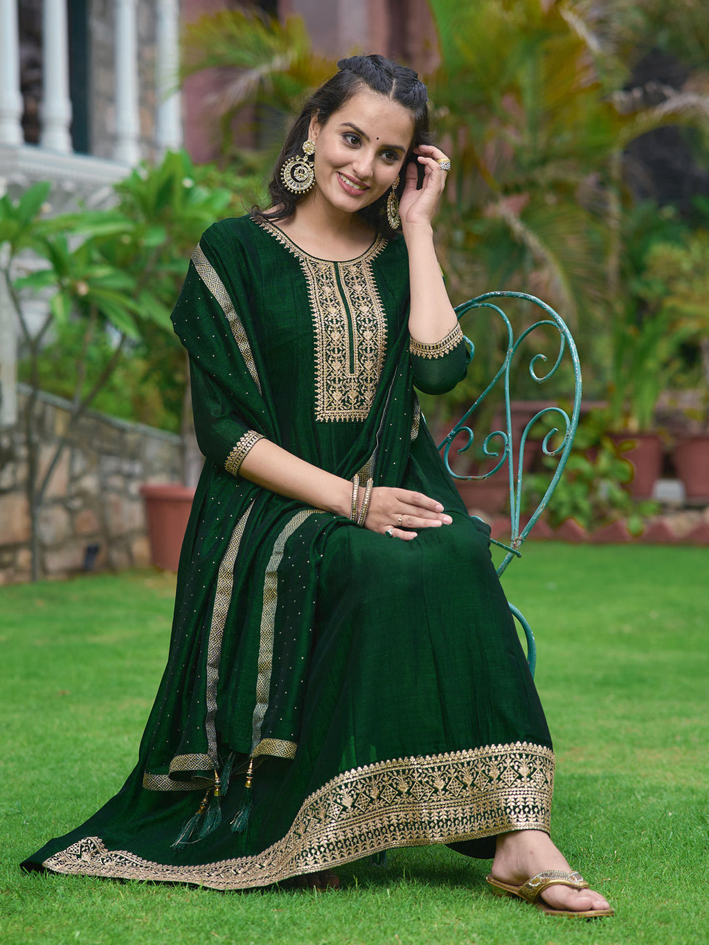 Bottle-green silk Anarkali kurta set with detailed embroidery and matching dupatta.