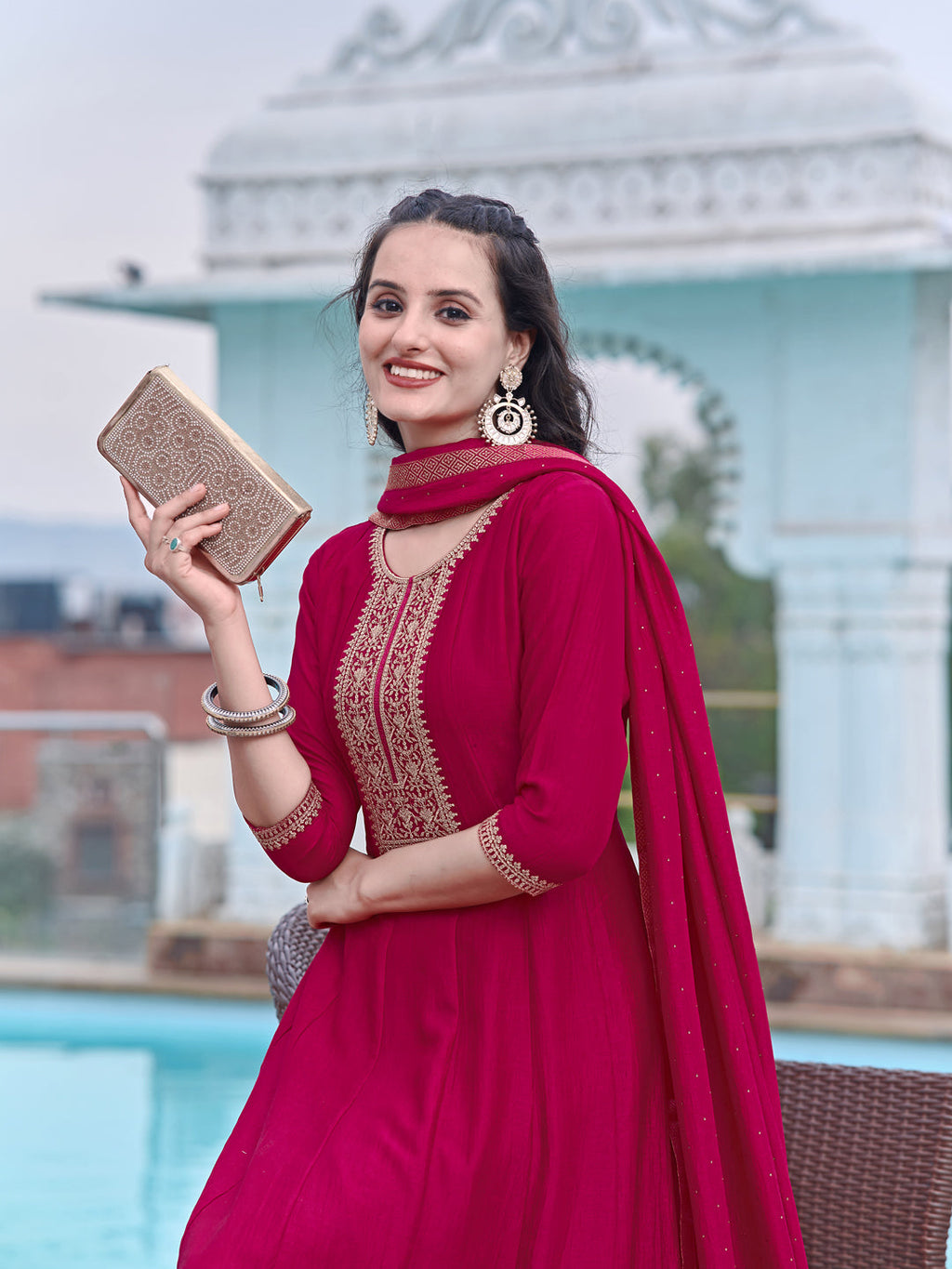 Pink silk Anarkali kurta set featuring intricate embroidery, paired with pants and a dupatta.