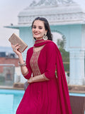 Pink silk Anarkali kurta set featuring intricate embroidery, paired with pants and a dupatta.