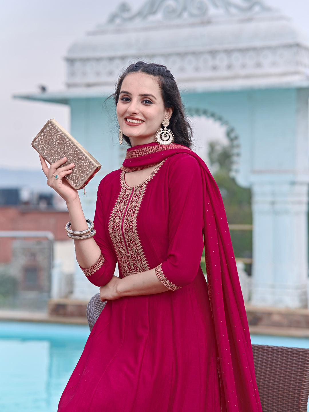 Pink silk Anarkali kurta set featuring intricate embroidery, paired with pants and a dupatta.