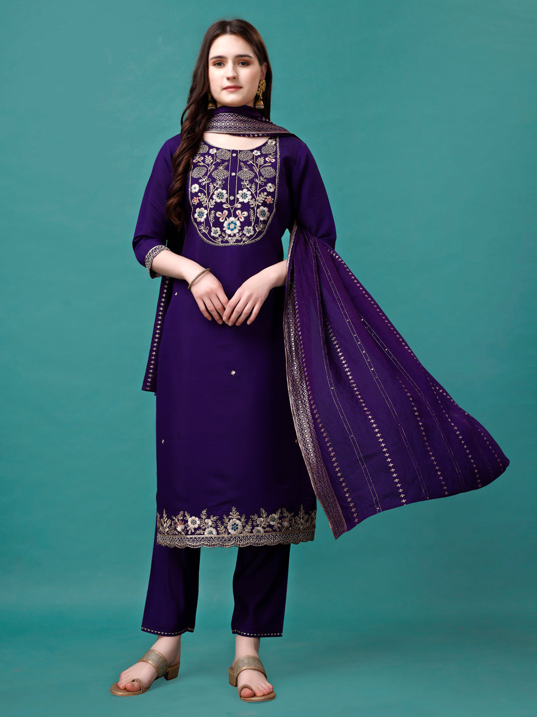 Model wearing a vibrant multicolor embroidered kurta set with a sequined dupatta and matching pants