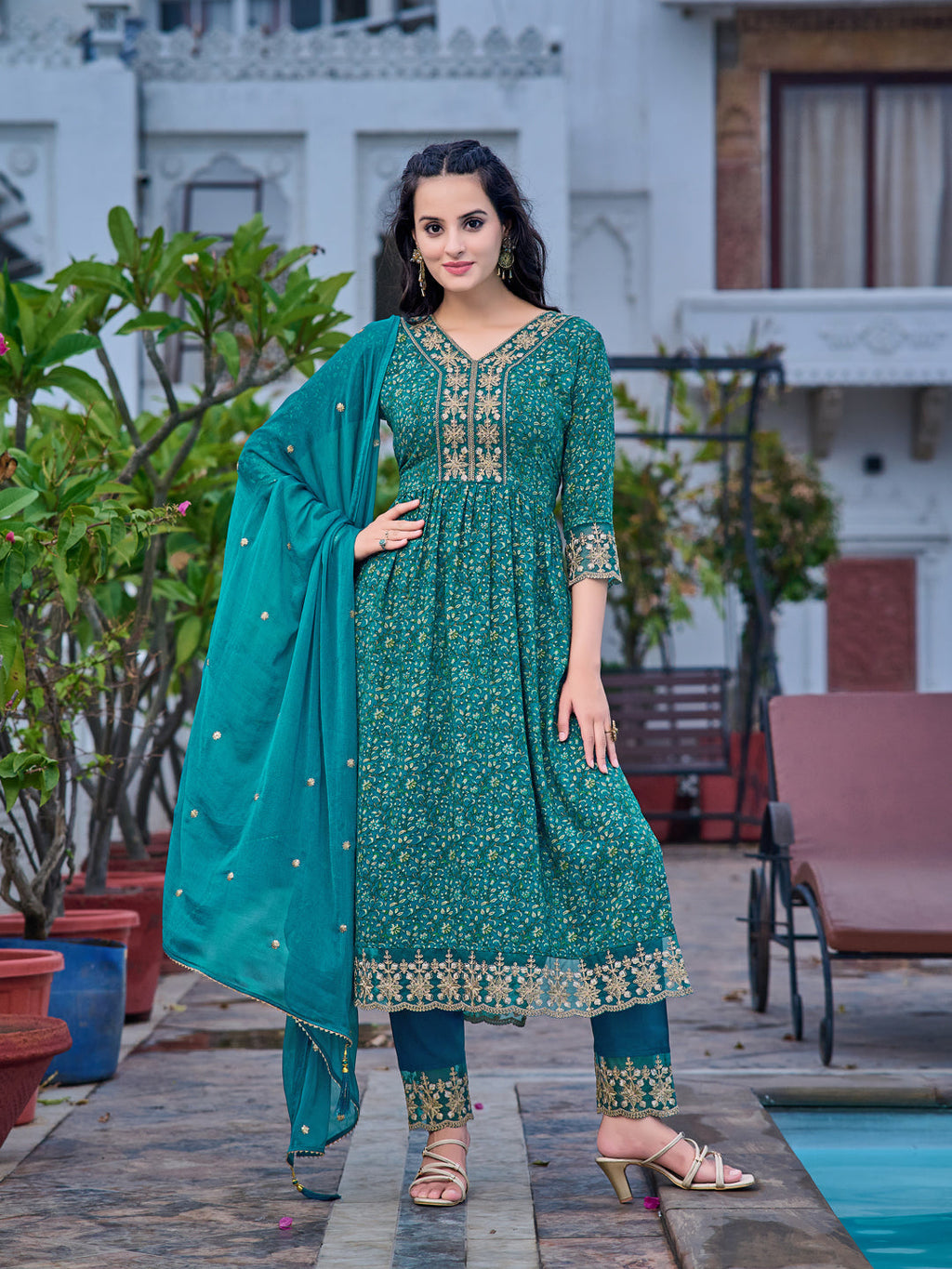 Teal Nyra cut kurta with floral prints, matching pants, and embroidered dupatta.