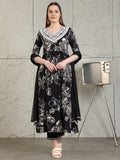 Black flared A-line kurta with floral prints and embroidery, worn with matching pants and dupatta.