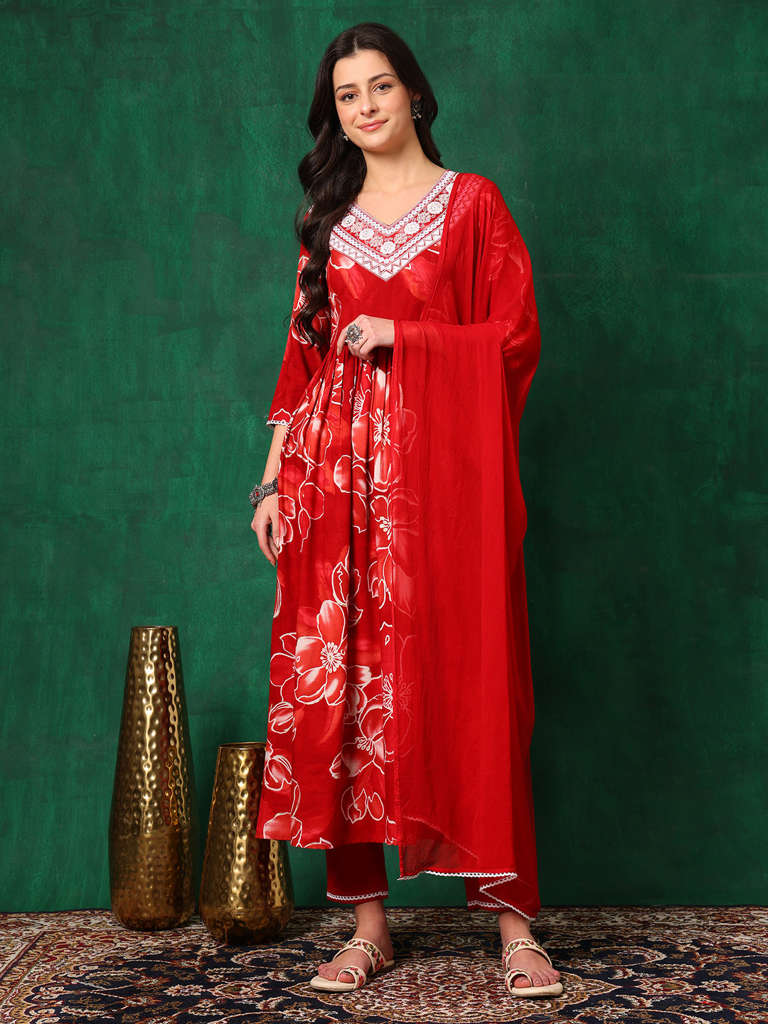 Model wearing a red floral printed flared A-line kurta with matching pants and dupatta