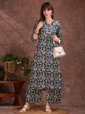 Woman wearing a teal rayon kurta with ethnic motifs and lace trim paired with matching palazzo pants