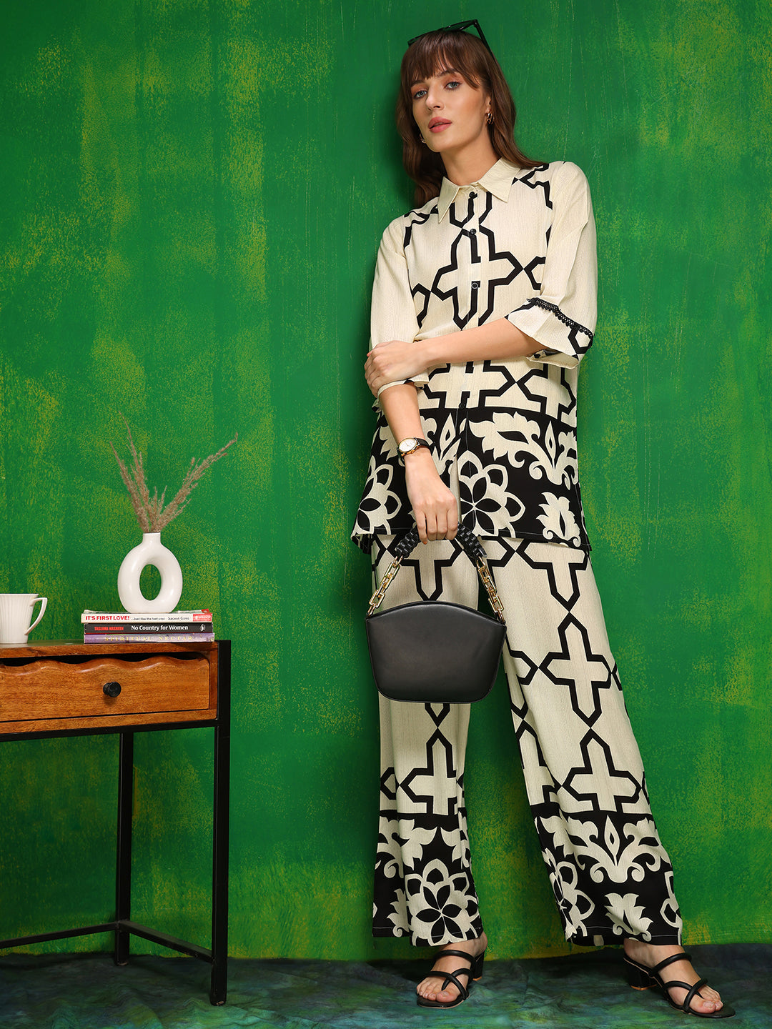Model wearing a cream printed co-ord set featuring a collar neck shirt and matching palazzo pants