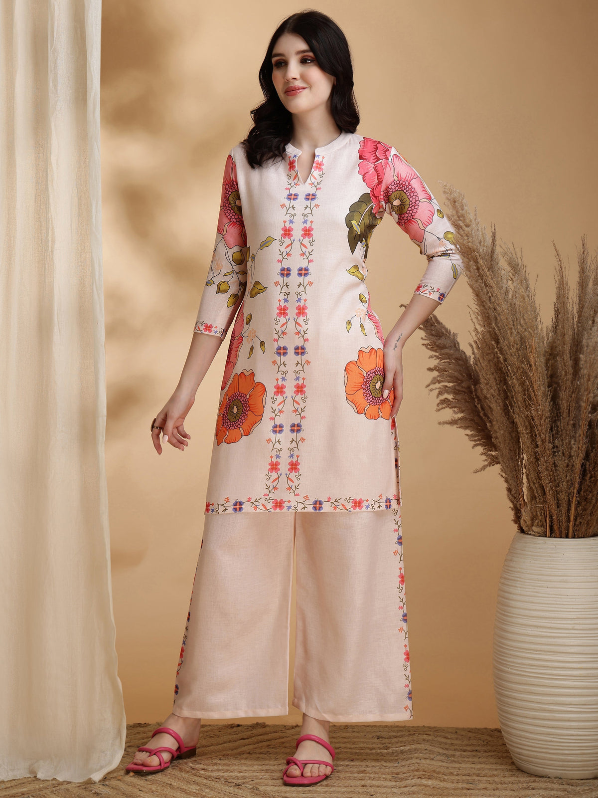 Woman wearing a beige floral print linen tunic and matching palazzo pants co-ord set
