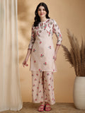 A beige linen co-ord set featuring a floral print tunic with a Chinese collar and matching palazzo pants.